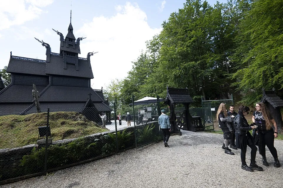 The dark-tarred, dragon-headed church among pines