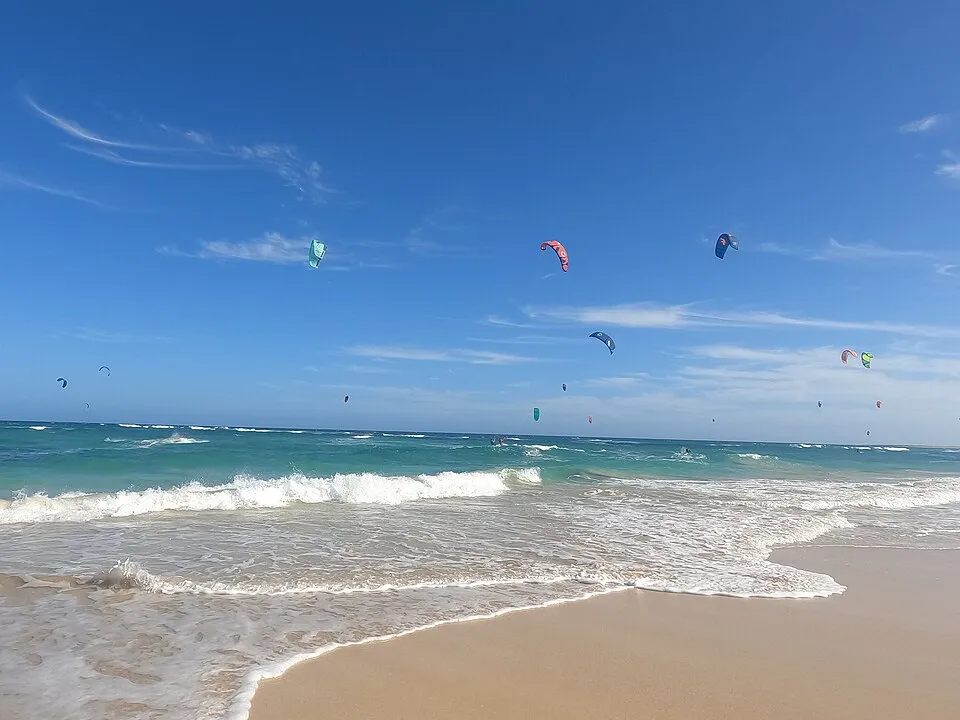 Kites over the turquoise surf at Kite Beach