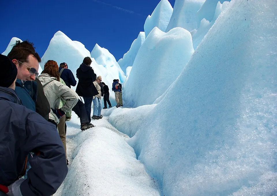 Walkers in crampons crossing the glacier ice